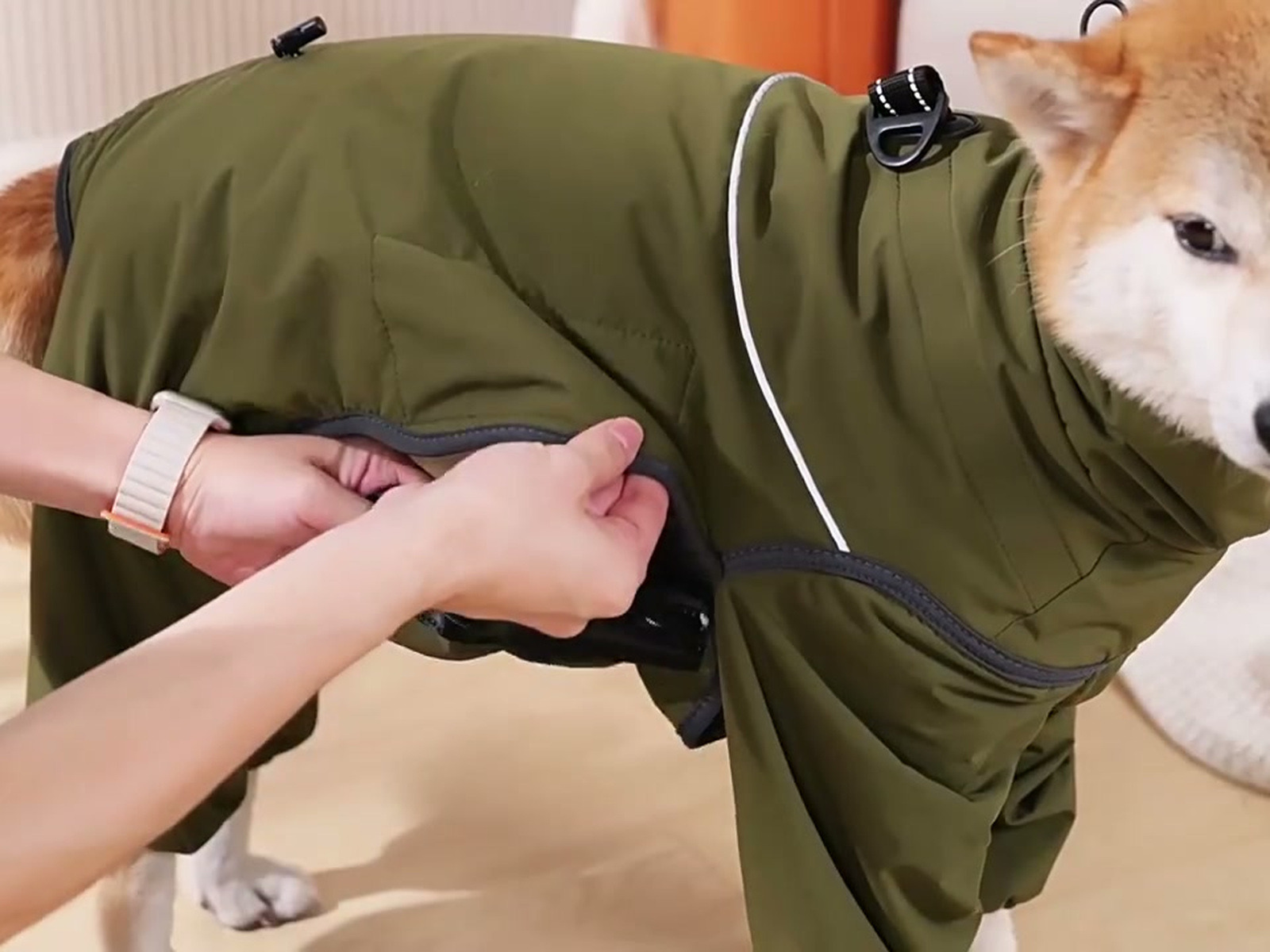 It closes along his side, not under him